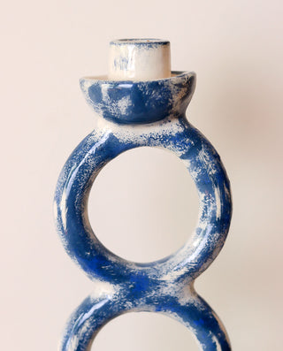Blue ceramic ring-shaped candle holder on a light background