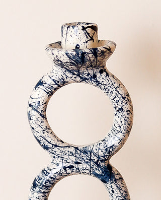 Splash blue and white candle holder on a beige background