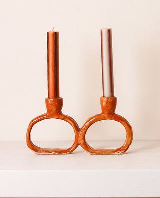 orange ceramic candle holder with candles on a white background