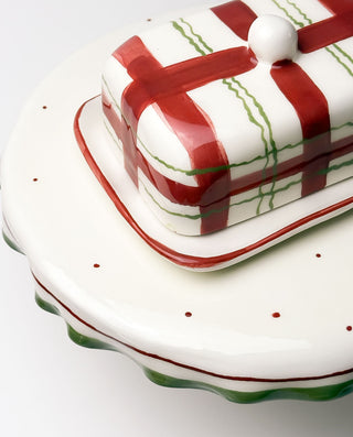 Decorative ceramic butter dish with red and green stripes on a white background