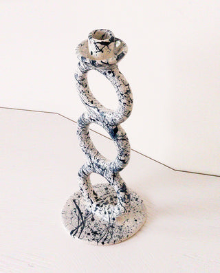 Decorative candle holder with a spiral design on a white background