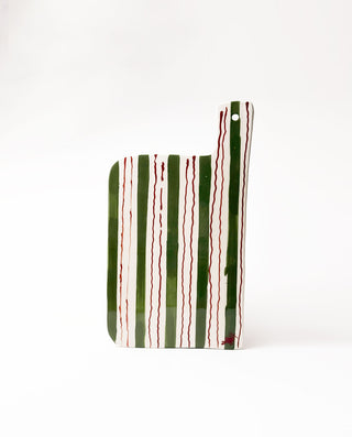 ceramic serving board with green and red striped pattern on a white background