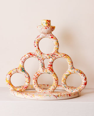 Decorative ceramic candle holder with colorful design on a white background