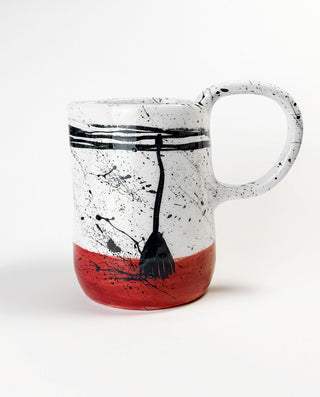 Greek Ceramic carafe with black abstract design and red base on a white background