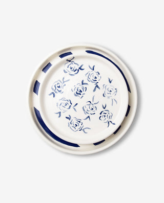 A round ceramic dessert plate with a royal blue border and white center, featuring a floral pattern.