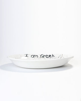 White ceramic plate with 'I am Greek' text on a white background