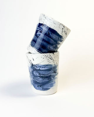 Two GREEK ceramic cups with blue and black abstract patterns on a white background