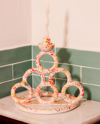 Decorative candle holder on a tiled wall background