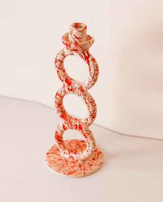 Handmade ceramic candle holder with orange splashes