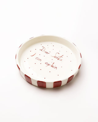 Small ceramic plate with red text on a white background