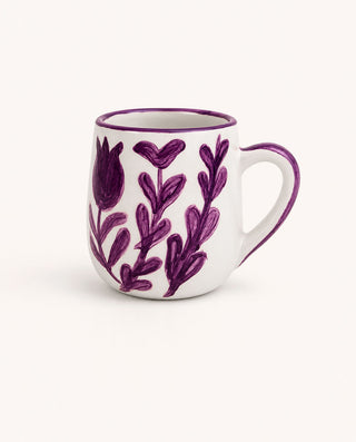 White mug with purple floral patterns on a white background