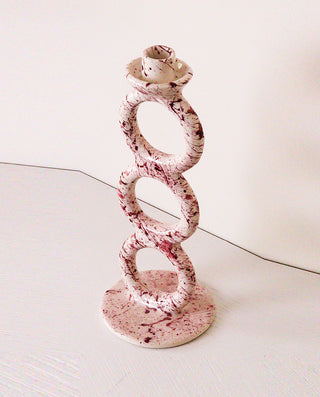 Marble-patterned candle holder on a white surface