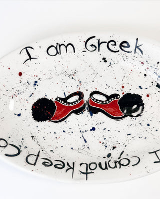 Decorative plate with Greek-themed design featuring tharouchi and text on a white background.
