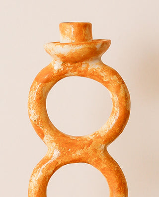 Decorative candle holder with a unique design on a beige background