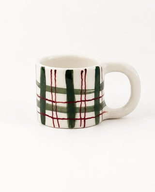 Forest green plaid ceramic mug with fine burgundy lines and ivory handle.