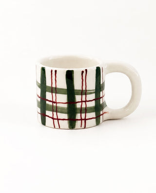 Forest green plaid ceramic mug with fine burgundy lines and ivory handle.