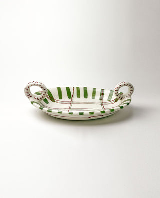 Ceramic dish with green stripes and handles on a white background