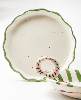 Ceramic pie dish with green and red accents on a white background