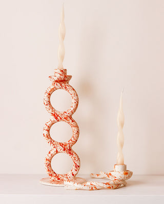 Decorative candle holders with a marble pattern on a light background
