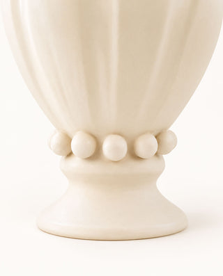 Detail of the handcrafted pedestal base of the Pearl ceramic vase, featuring spherical ornaments and a matte white finish.