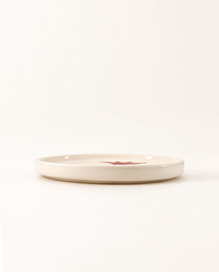 Handmade Greek ceramic dinner plate featuring a red pomegranate on glossy ivory glaze